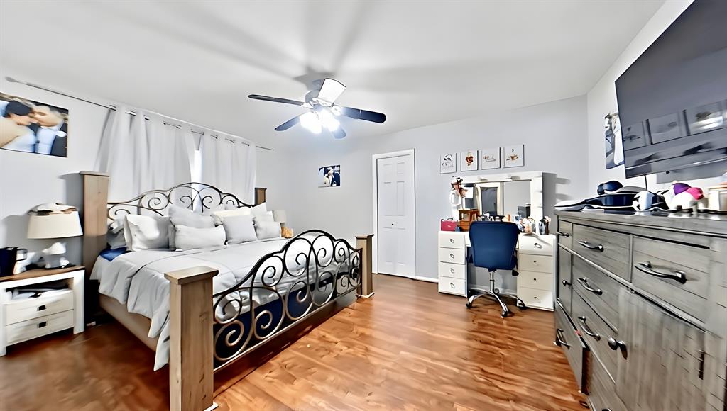 5016 St Lawrence Road Fort Worth, TX 76103 - Photo 13 of 22 a bedroom with a bed and a chandelier