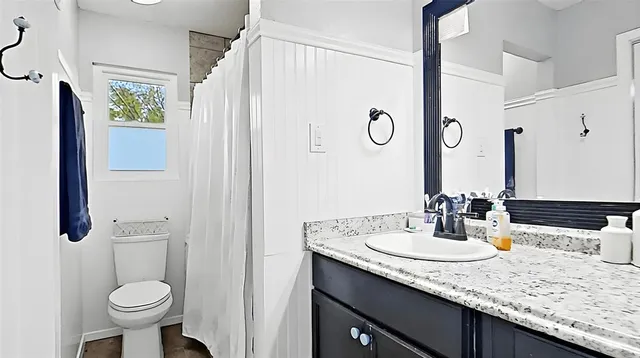 a bathroom with a sink toilet and shower