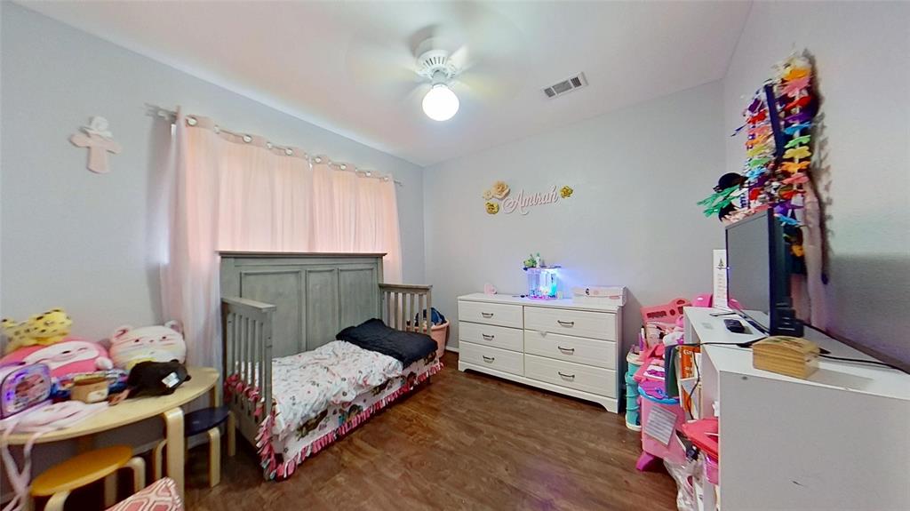 5016 St Lawrence Road Fort Worth, TX 76103 - Photo 19 of 22 a bedroom with a bed and a window