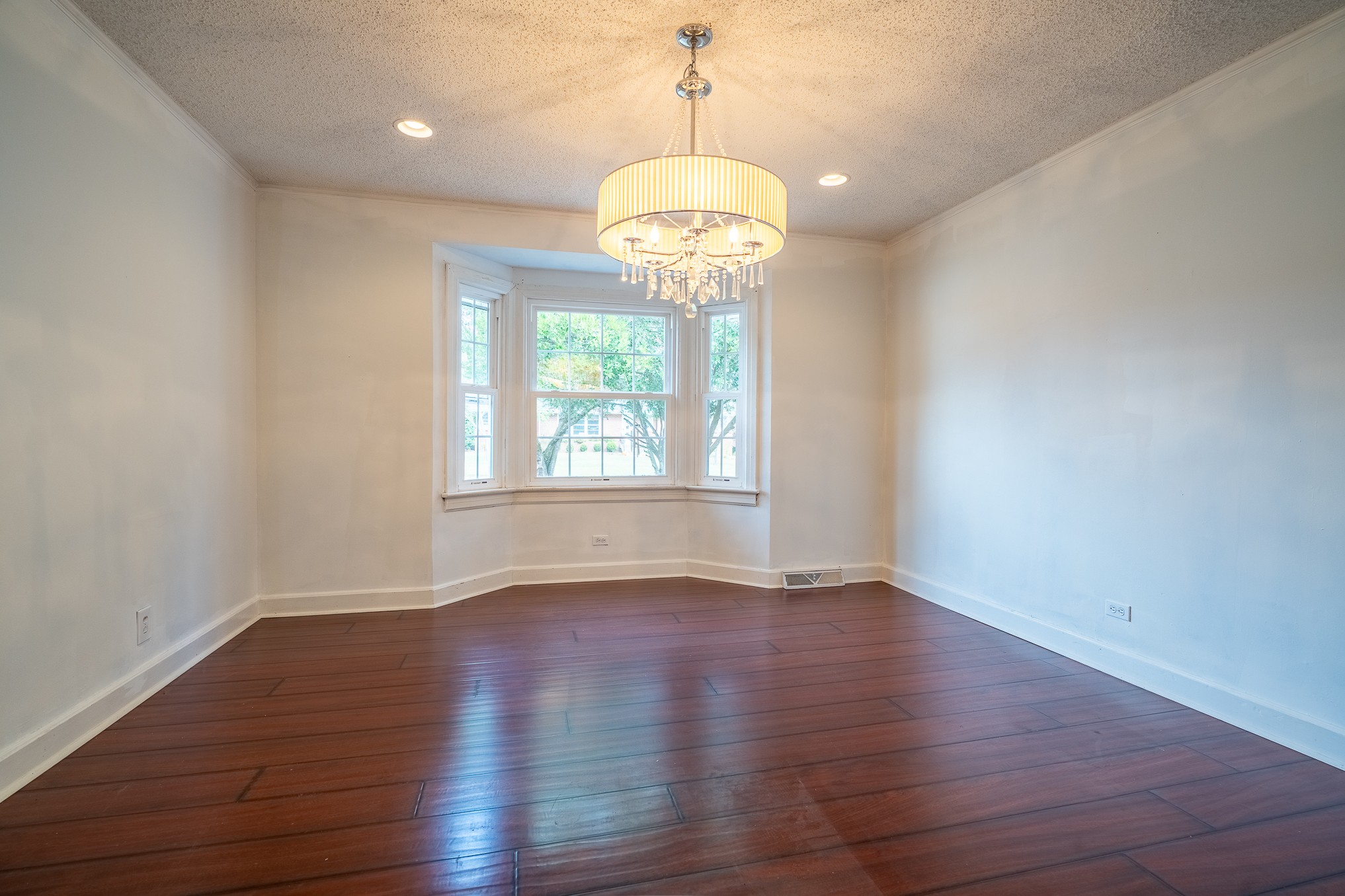 523 Highland Avenue Pulaski, TN 38478 - Photo 11 of 44 a view of an empty room with wooden floor and a window