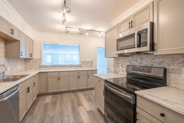 a kitchen with a stove and a microwave