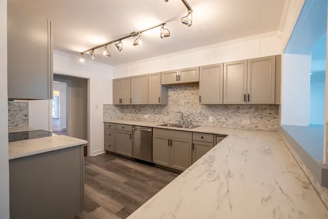 a kitchen with granite countertop cabinets stainless steel appliances and a sink