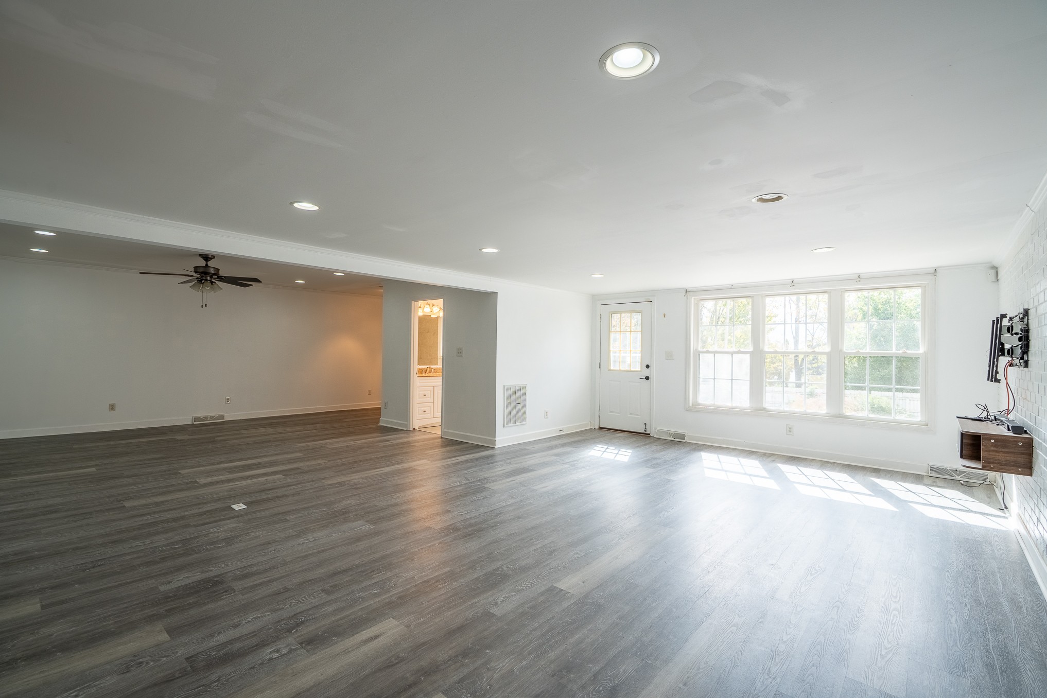 523 Highland Avenue Pulaski, TN 38478 - Photo 17 of 44 an empty room with wooden floor and windows