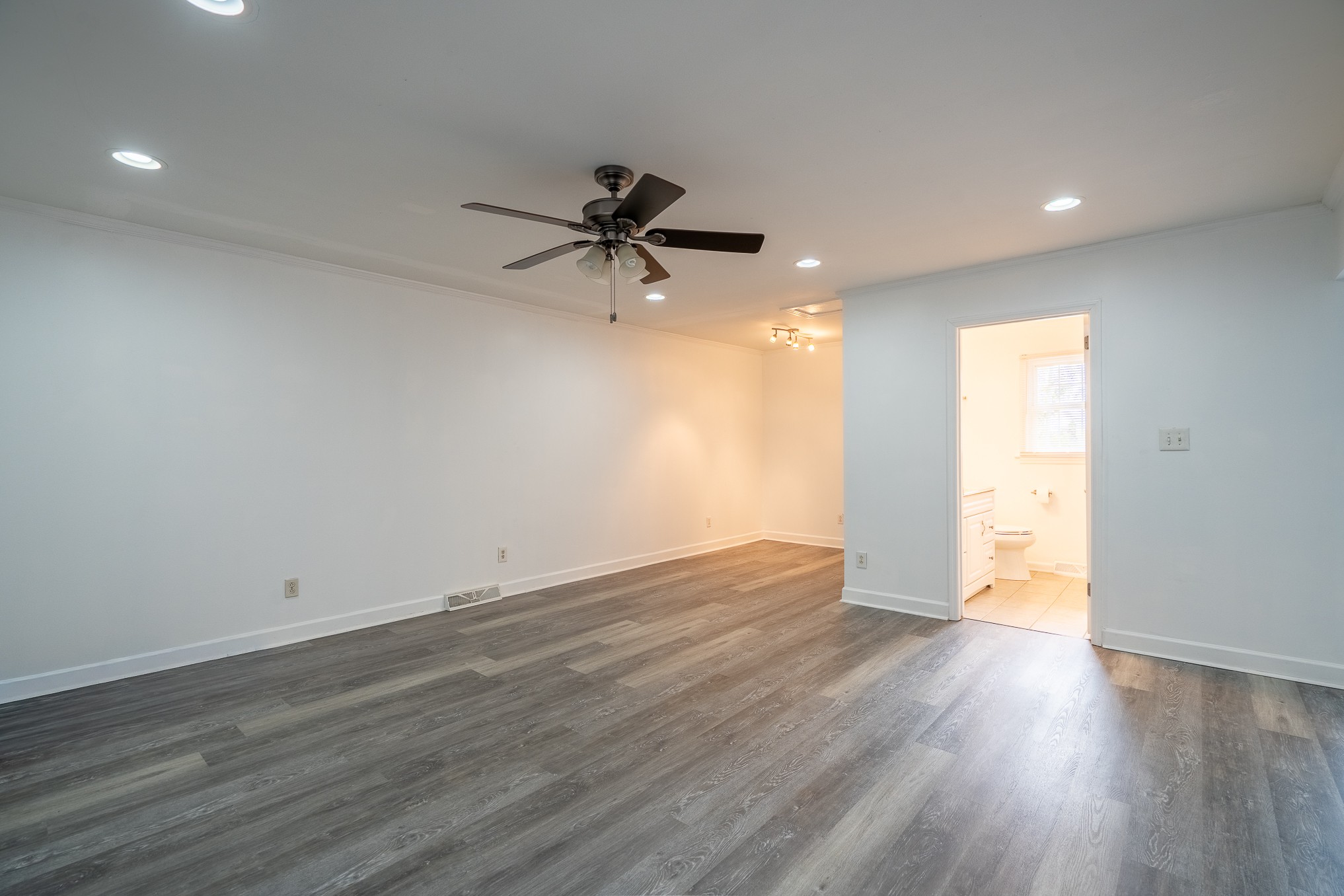 523 Highland Avenue Pulaski, TN 38478 - Photo 30 of 44 an empty room with wooden floor and a ceiling fan