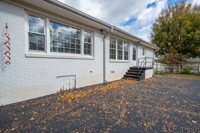 a view of a yard with large trees