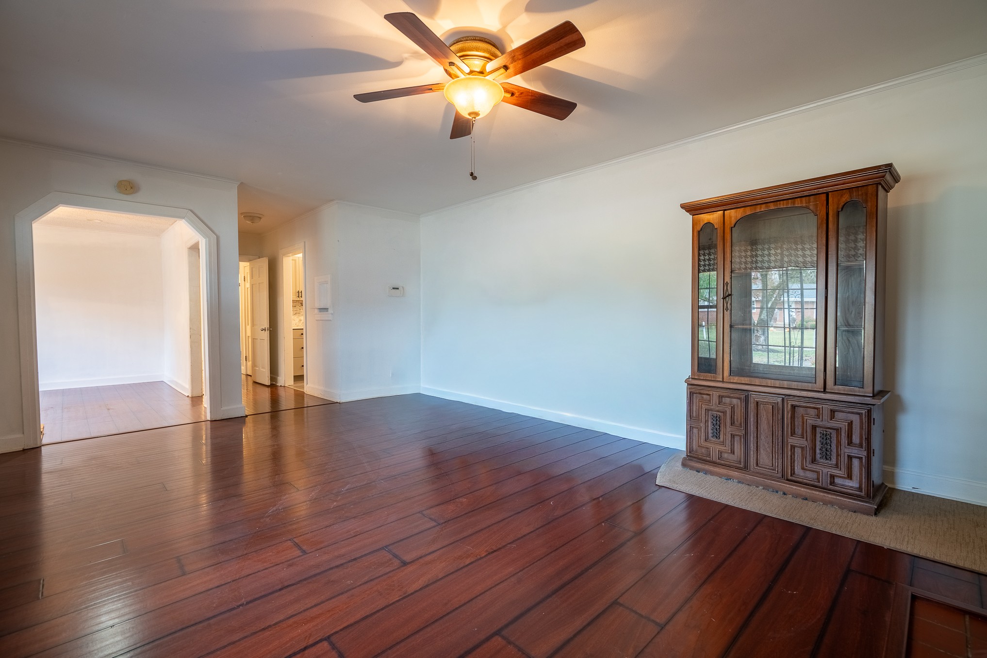 523 Highland Avenue Pulaski, TN 38478 - Photo 7 of 44 a view of an empty room with window and wooden floor