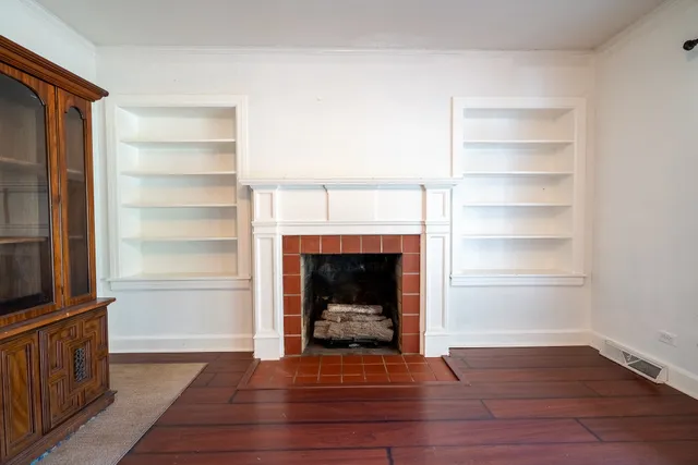 a view of a livingroom with a fireplace and a window