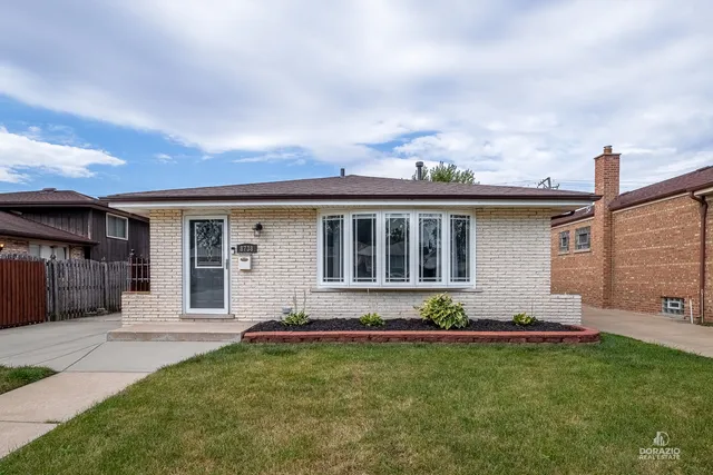 a view of a house with backyard sitting area and garden