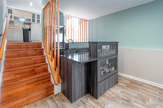 a view of entryway with stairs and wooden floor