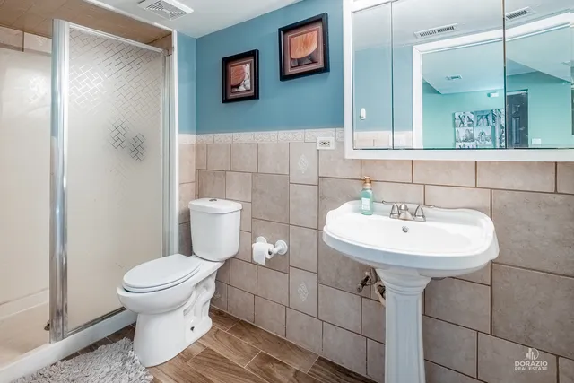 a bathroom with a sink toilet and a mirror