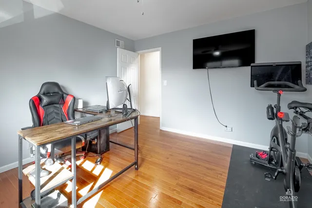 a view of a workspace with furniture and a flat screen tv