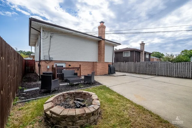 a backyard of a house with yard and outdoor seating