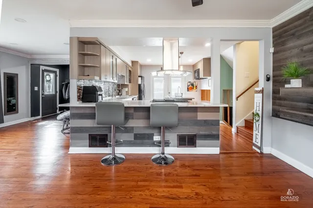 a living room with fireplace furniture and a wooden floor