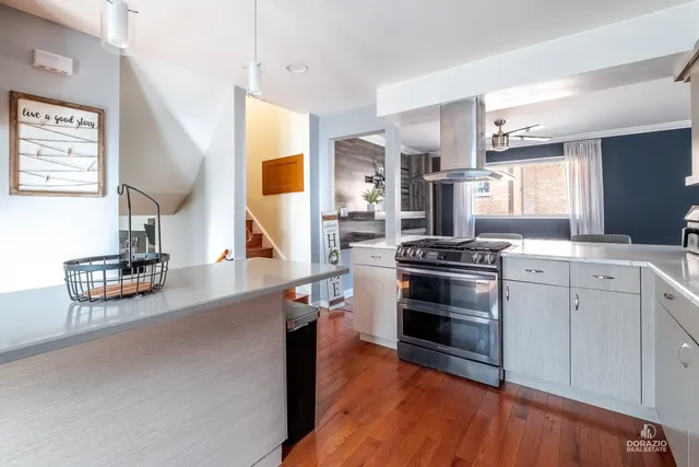 a kitchen with stainless steel appliances a stove a sink and a refrigerator