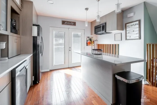 a kitchen with stainless steel appliances a microwave a stove and a refrigerator