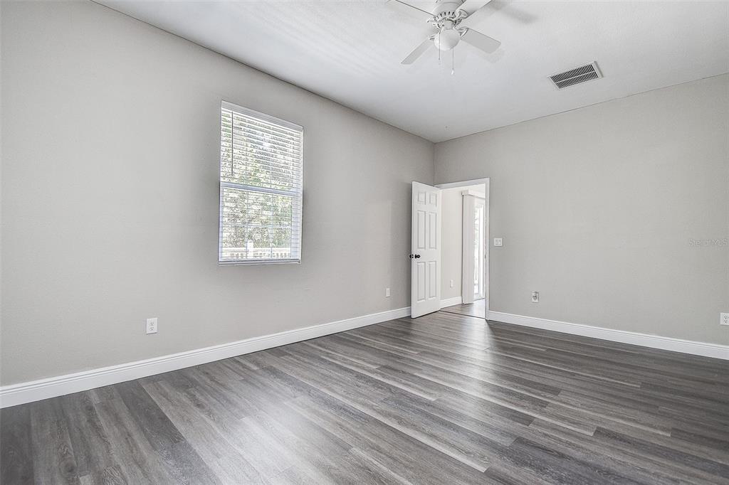 16519 US Highway 41 Spring Hill, FL 34610 - Photo 18 of 37 wooden floor in an empty room with a window