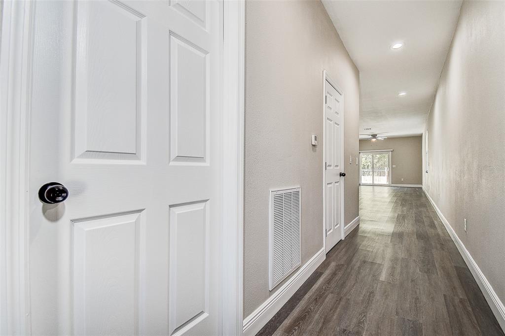 16519 US Highway 41 Spring Hill, FL 34610 - Photo 4 of 37 a view of a hallway with wooden floor and staircase