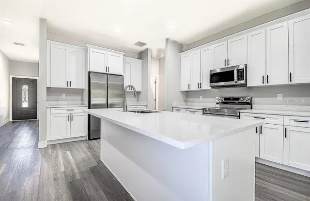 a view of a small space with wooden floor and a window