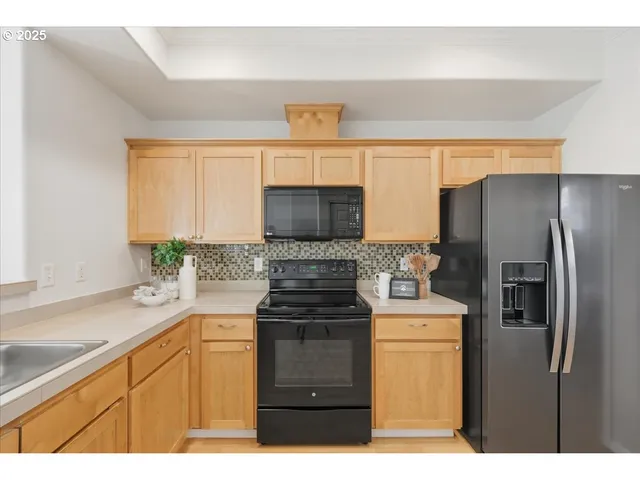 a dining room with wooden floor a chandelier a wooden table and chairs