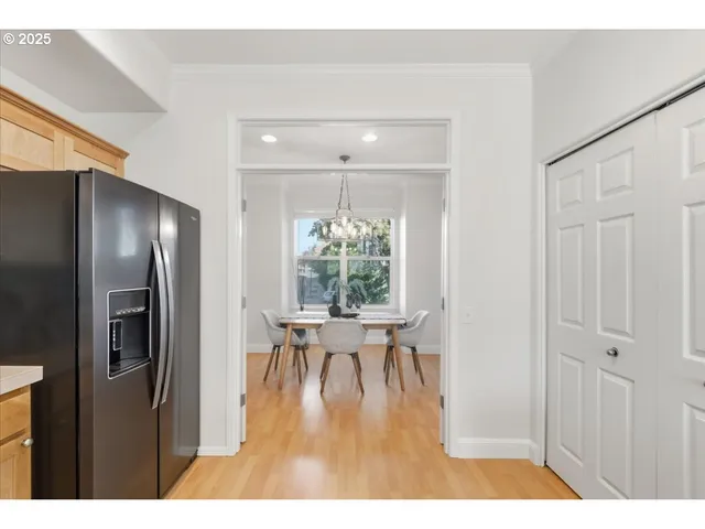 a view of a livingroom and a dining room with wooden floor