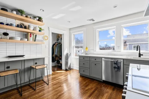 a kitchen with stainless steel appliances granite countertop a stove and cabinets