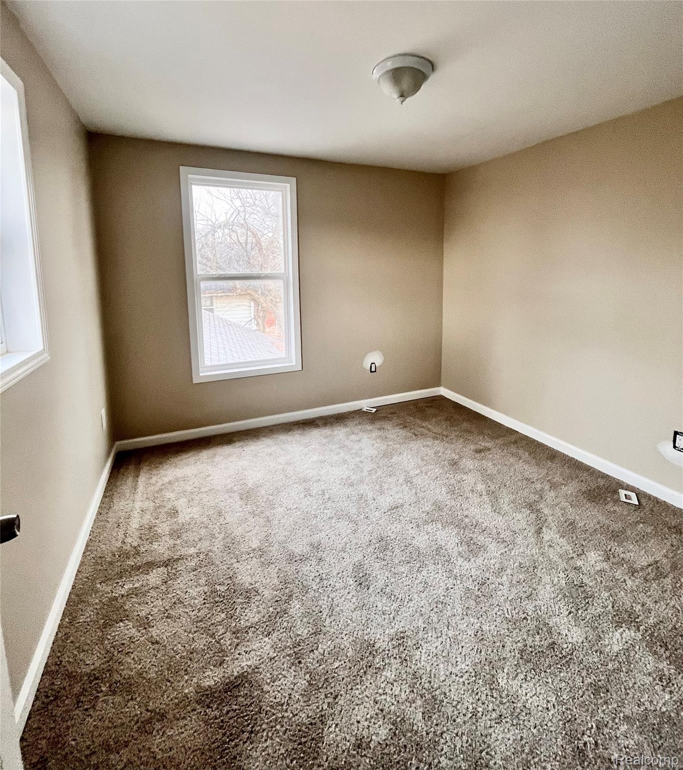 2410 Corunna Road Flint, MI 48503 - Photo 19 of 20 Unfurnished room with carpet floors and baseboards