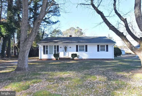 a front view of a house with yard patio and green space
