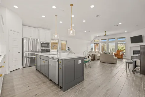 a view of a kitchen with a sink and a fireplace