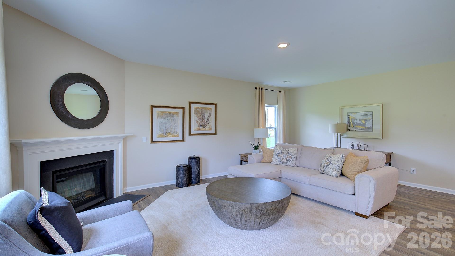 85 Salers Road Fletcher, NC 28732 - Photo 11 of 46 a living room with furniture a rug a fireplace and a window