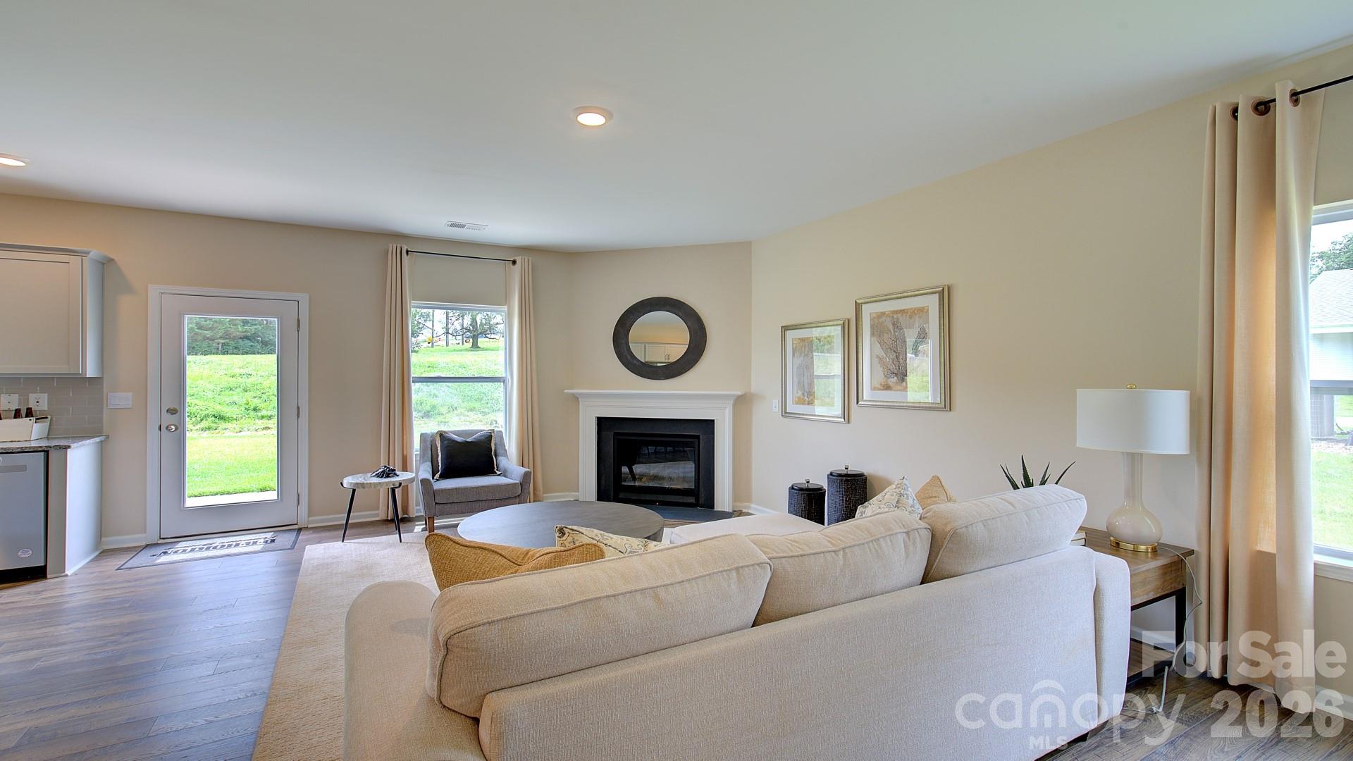 85 Salers Road Fletcher, NC 28732 - Photo 13 of 46 a living room with furniture a fireplace and a window