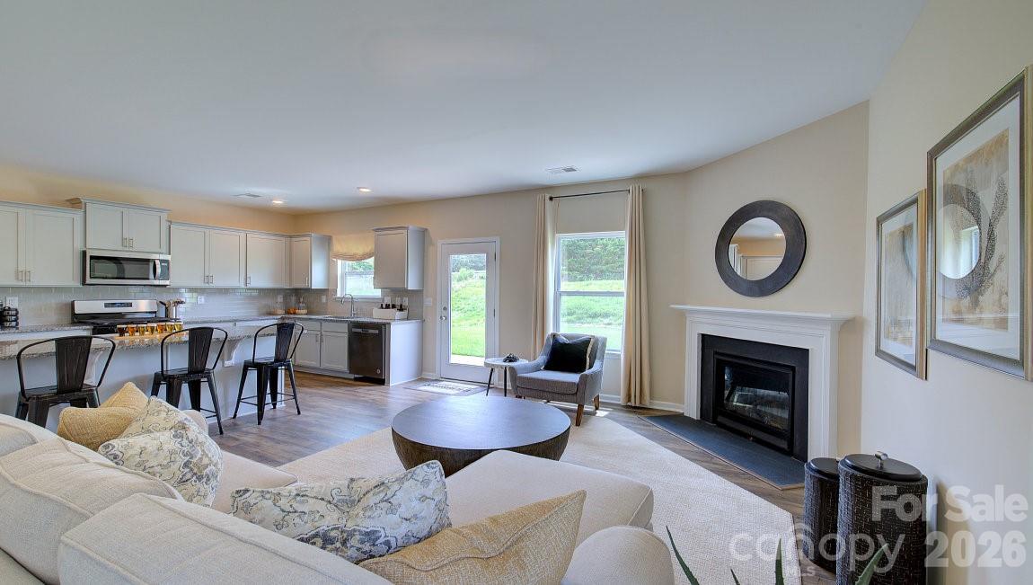 85 Salers Road Fletcher, NC 28732 - Photo 14 of 46 a living room with furniture a fireplace a rug and a window