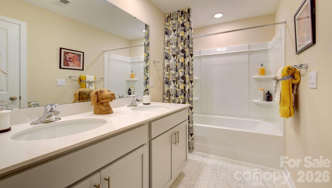 85 Salers Road Fletcher, NC 28732 - Photo 25 of 46 a bathroom with a granite countertop sink a mirror a shower and a bathtub