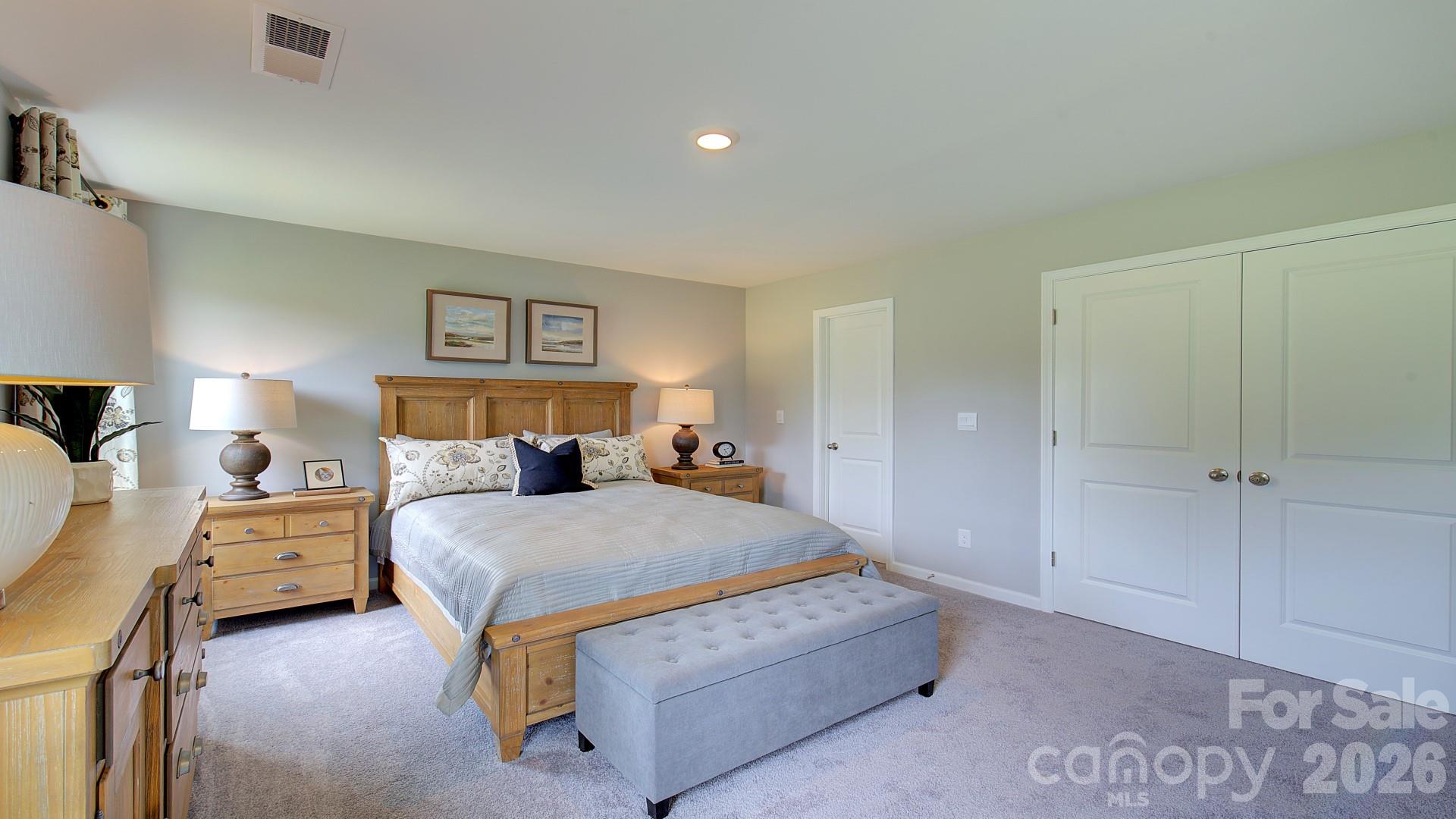 85 Salers Road Fletcher, NC 28732 - Photo 31 of 46 a bedroom with a bed and a lamp