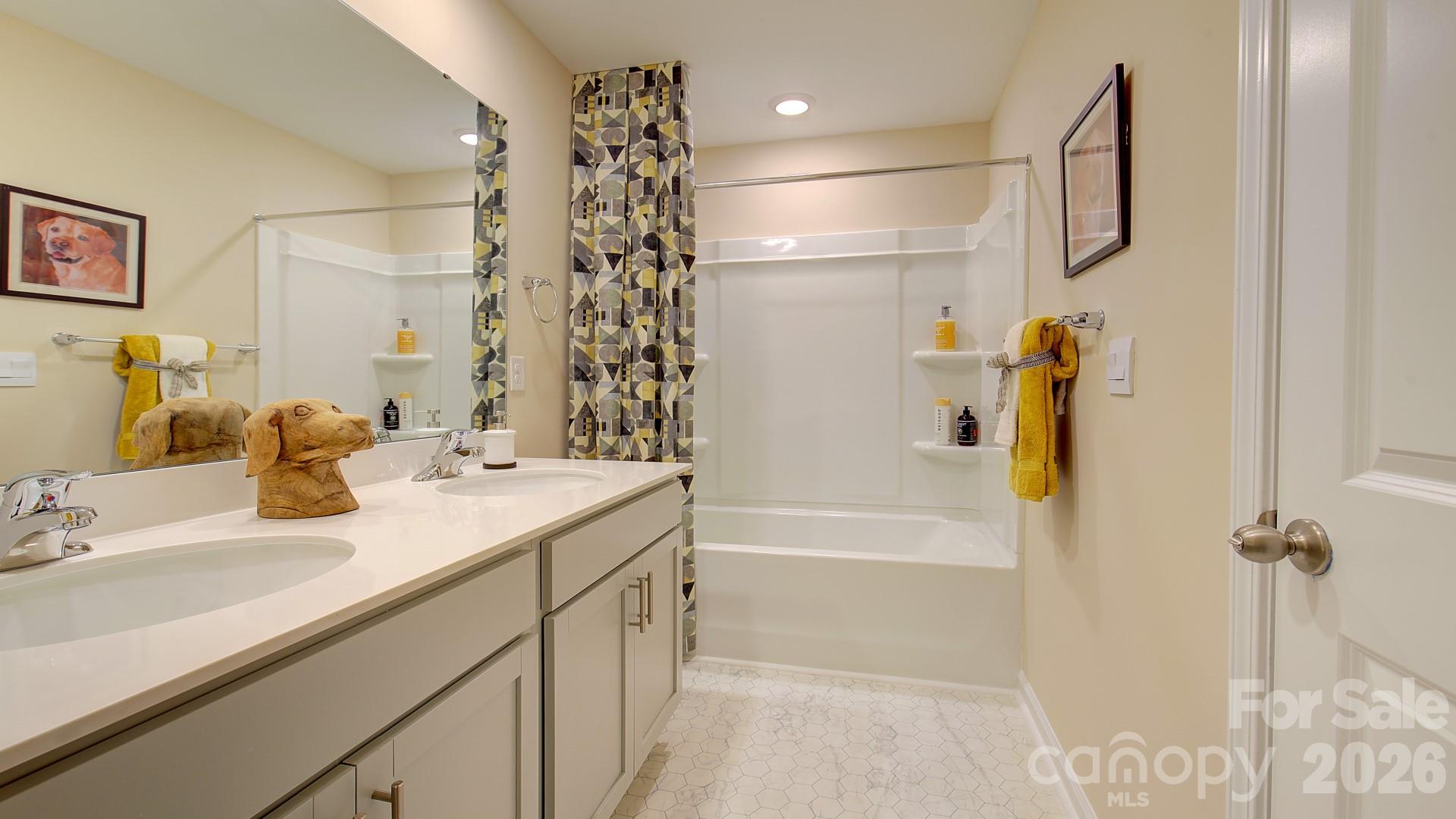 85 Salers Road Fletcher, NC 28732 - Photo 34 of 46 a bathroom with a granite countertop sink a mirror a bathtub and shower