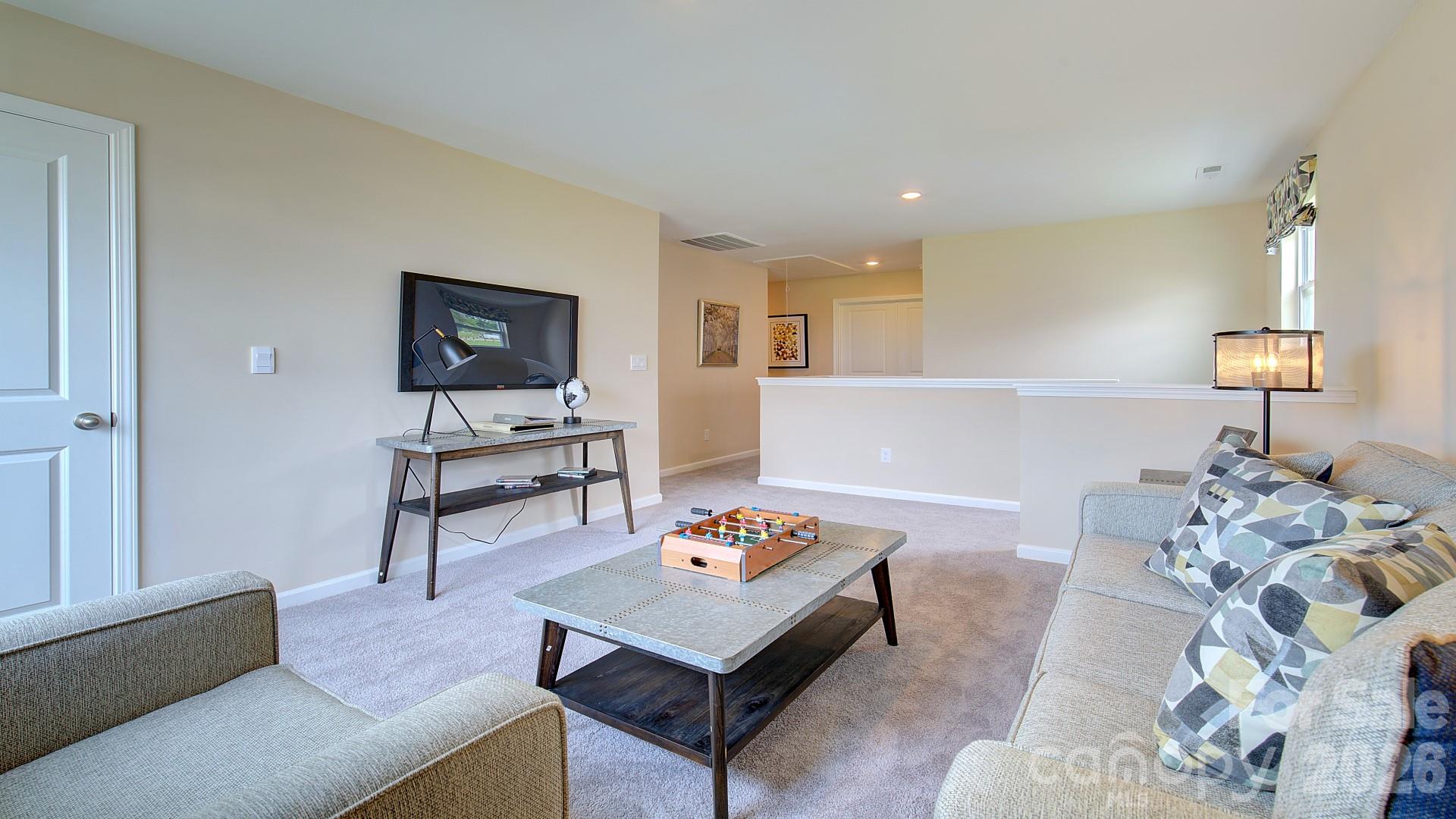 85 Salers Road Fletcher, NC 28732 - Photo 36 of 46 a living room with furniture and a flat screen tv