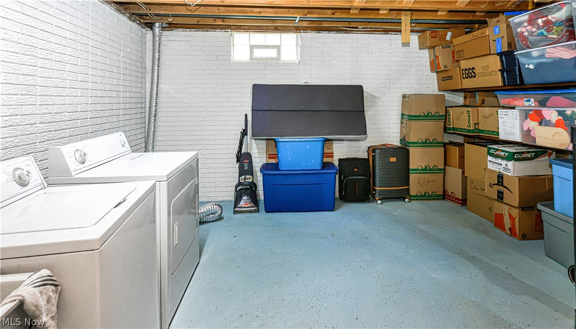 834 Wadsworth Road, Unit B1 Medina, OH 44256 - Photo 19 of 23 Clothes washing area with brick wall and washer and clothes dryer
