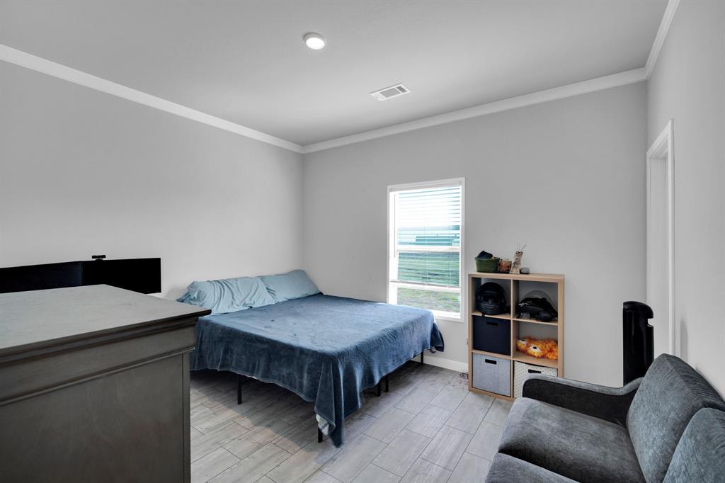 129 Old Blooming Grove Road Italy, TX 76651 - Photo 16 of 22 a bedroom with a bed and a view of kitchen
