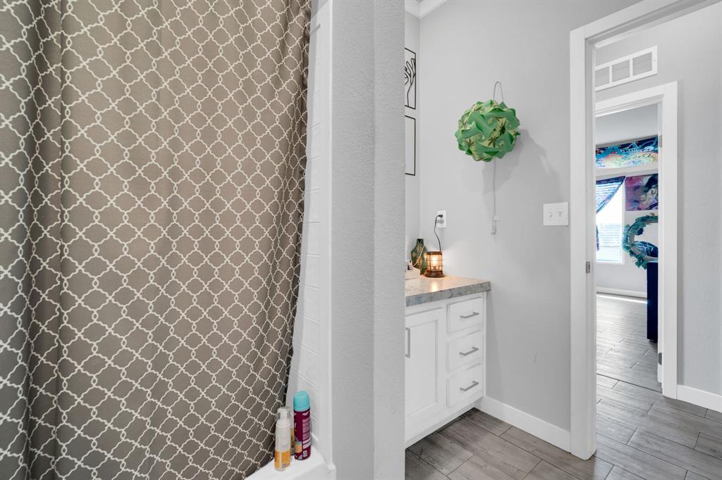 129 Old Blooming Grove Road Italy, TX 76651 - Photo 17 of 22 a hallway with painting on the wall and a wooden floor