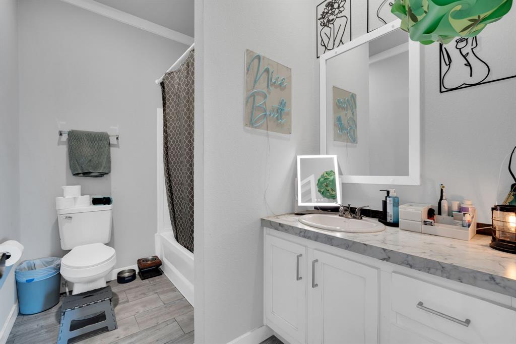 129 Old Blooming Grove Road Italy, TX 76651 - Photo 19 of 22 a bathroom with a granite countertop sink a toilet and mirror