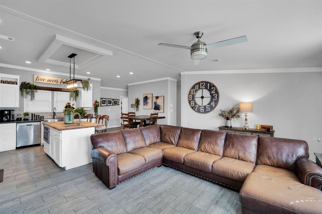129 Old Blooming Grove Road Italy, TX 76651 - Photo 2 of 22 a living room with a couch and a clock