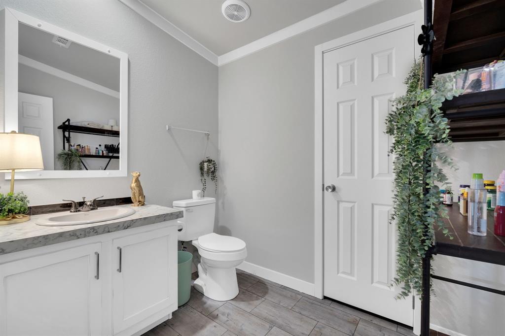 129 Old Blooming Grove Road Italy, TX 76651 - Photo 21 of 22 a bathroom with a granite countertop sink toilet and mirror