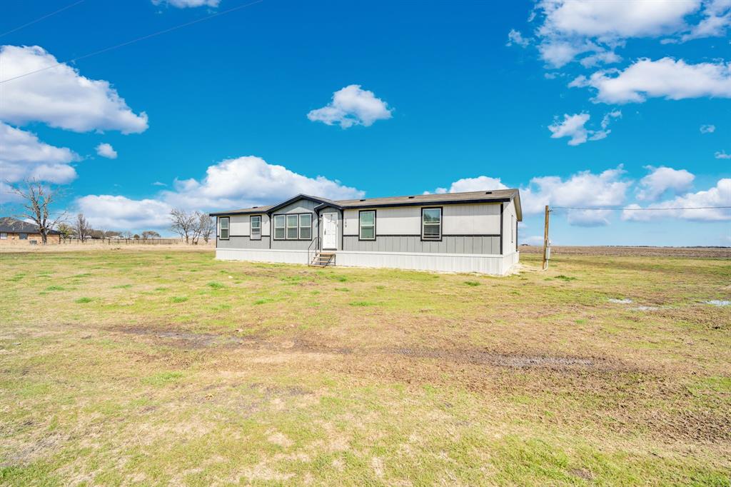 129 Old Blooming Grove Road Italy, TX 76651 - Photo 22 of 22 a view of a swimming pool with a lawn chairs under an umbrella