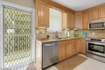 5600 Bonita Beach Road Southwest, Unit 503 Bonita Springs, FL 34134 - Photo 3 of 5 a kitchen with stainless steel appliances granite countertop a stove a sink and a microwave