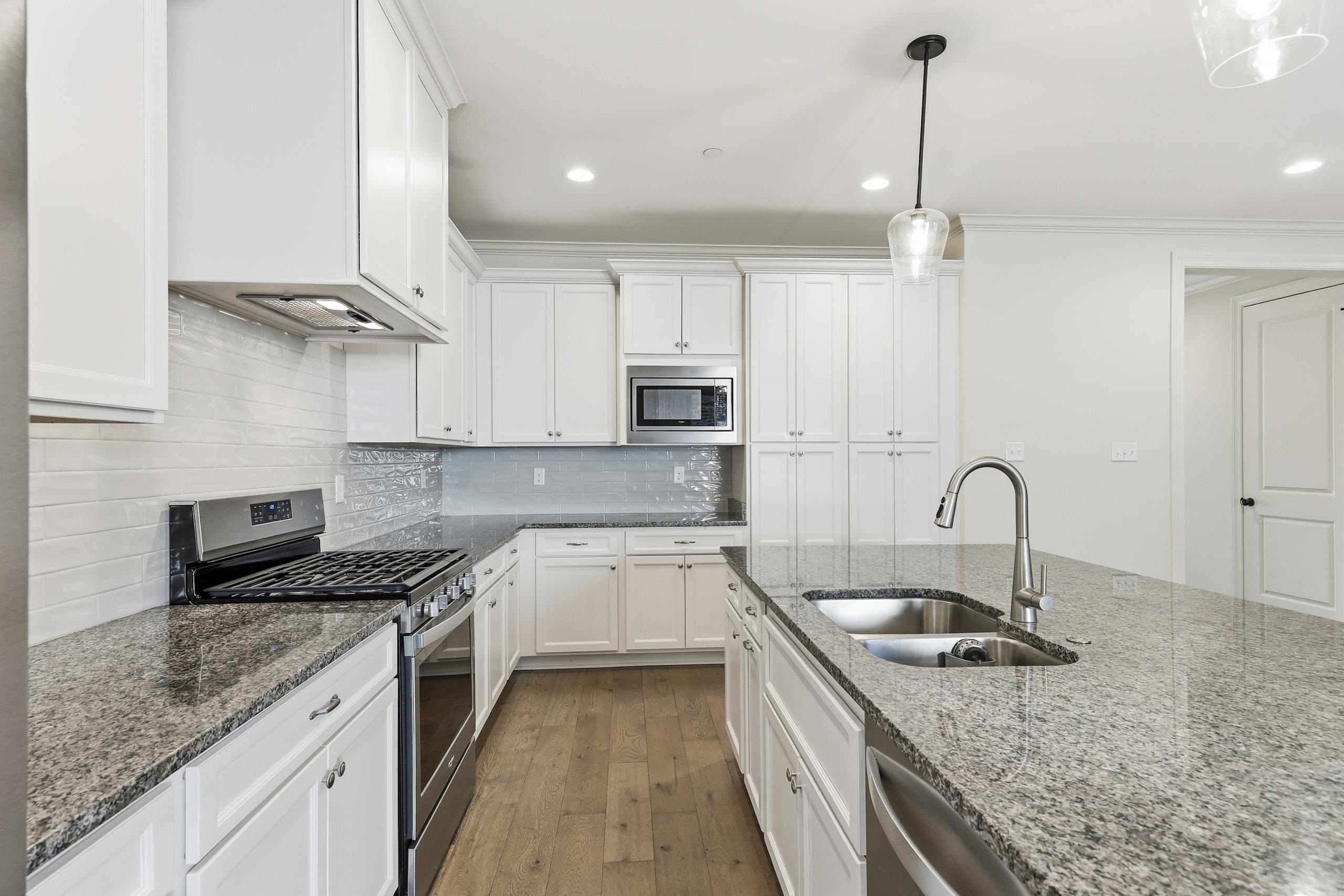 897 Ufton Alley Collierville, TN 38017 - Photo 7 of 32 a kitchen with stainless steel appliances granite countertop a sink a stove and a granite counter tops