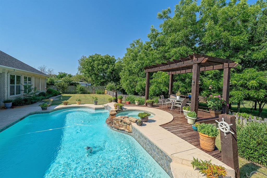 a view of a swimming pool with furniture