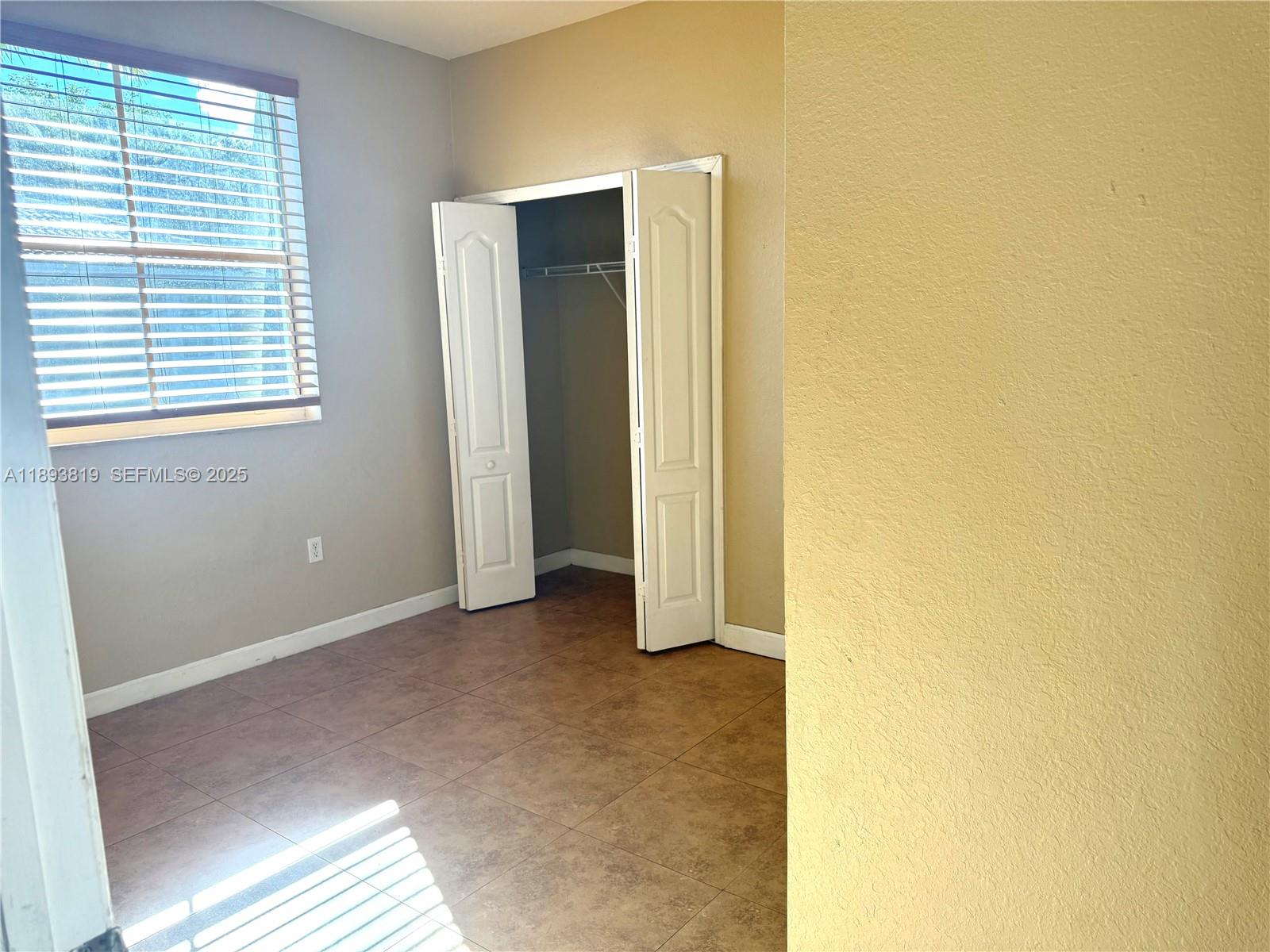 1656 Southeast 29th Court, Unit 207 Homestead, FL 33035 - Photo 12 of 31 a view of a room with window