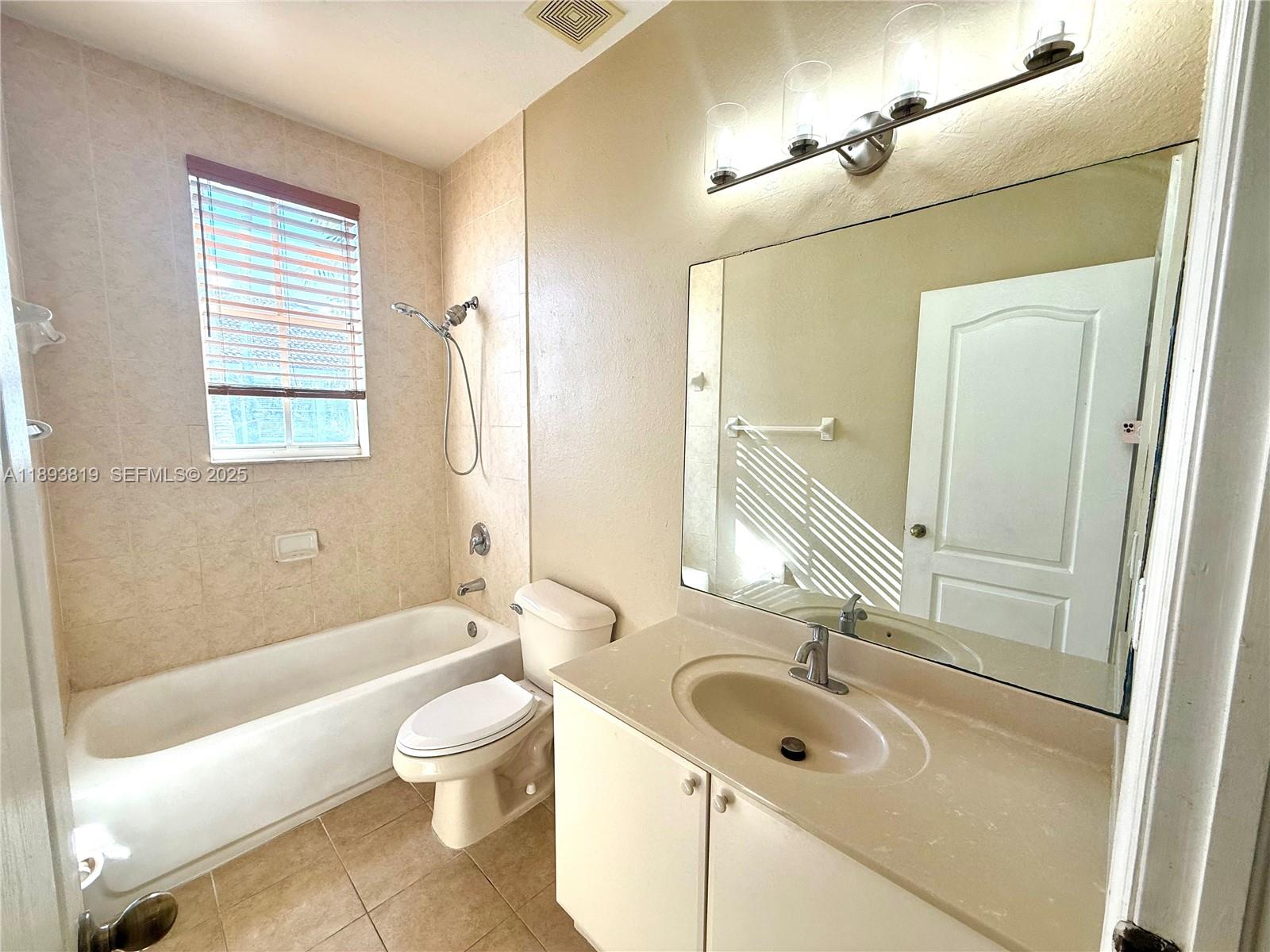 1656 Southeast 29th Court, Unit 207 Homestead, FL 33035 - Photo 15 of 31 a bathroom with a sink a toilet and a bathtub