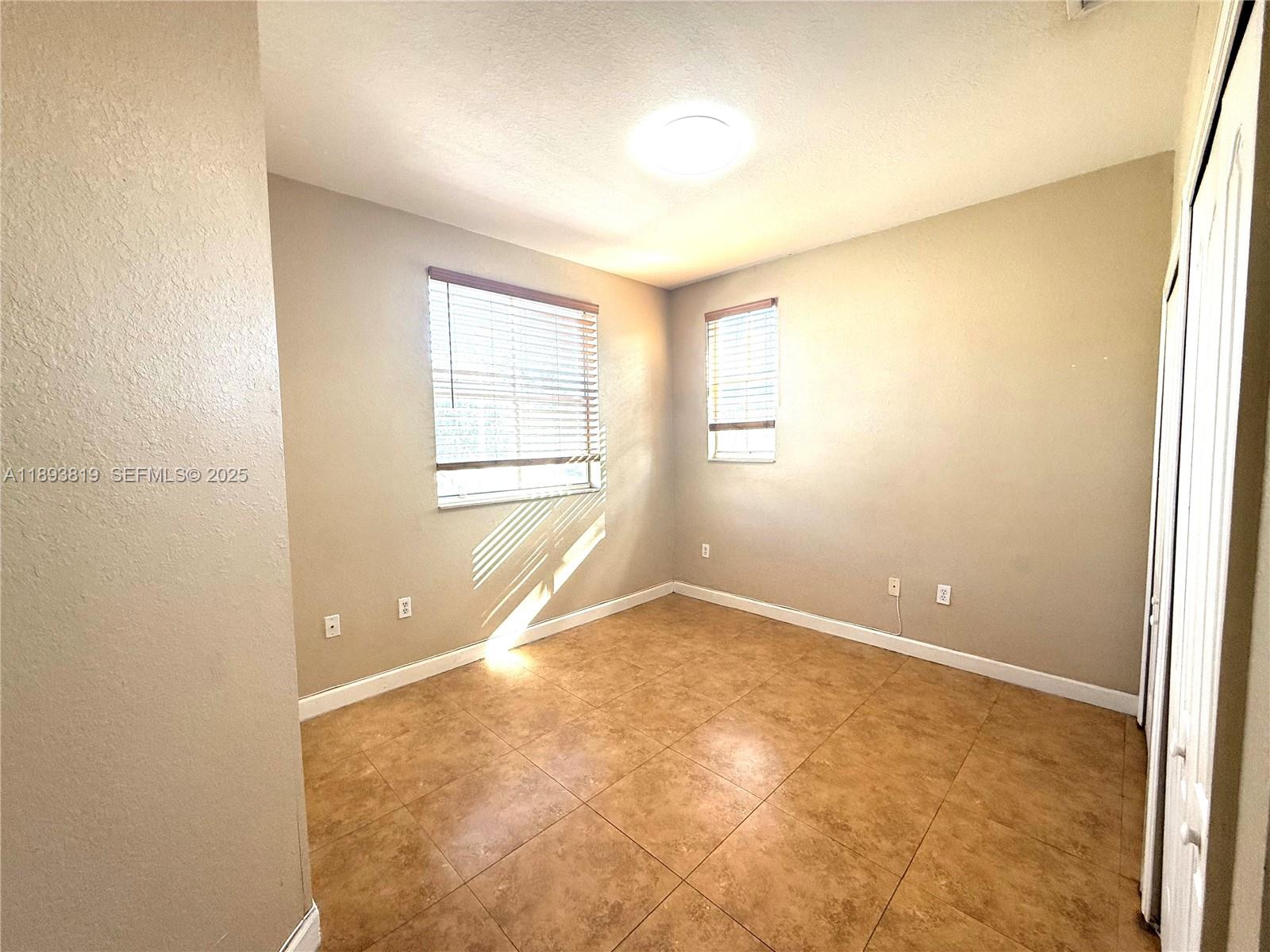 1656 Southeast 29th Court, Unit 207 Homestead, FL 33035 - Photo 16 of 31 an empty room with windows