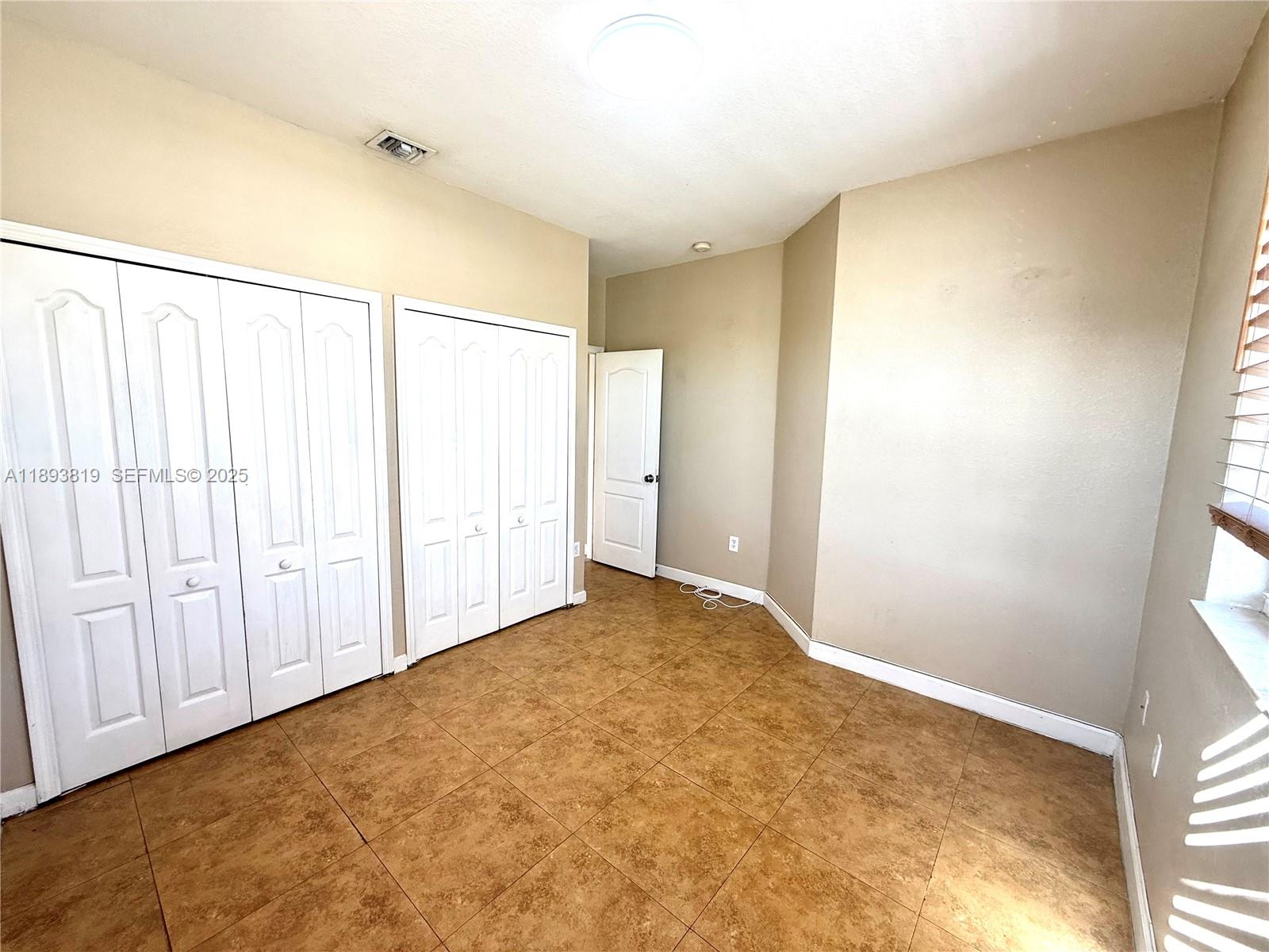 1656 Southeast 29th Court, Unit 207 Homestead, FL 33035 - Photo 17 of 31 a view of an empty room and window
