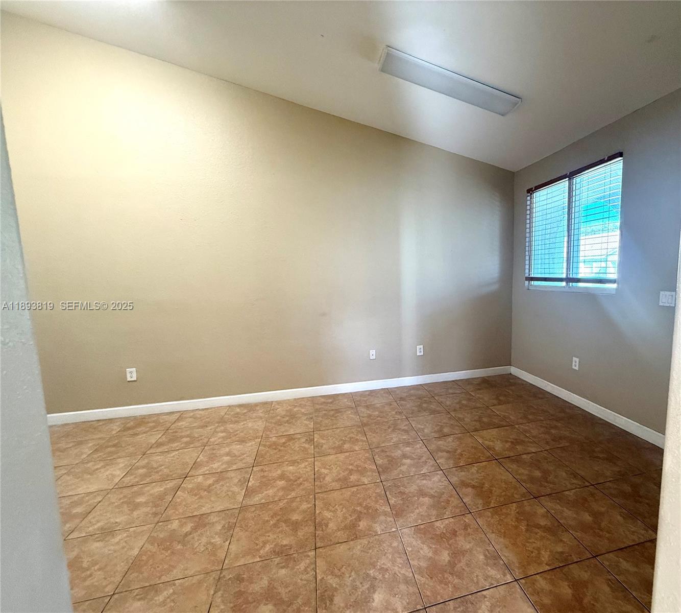 1656 Southeast 29th Court, Unit 207 Homestead, FL 33035 - Photo 19 of 31 an empty room with a natural light